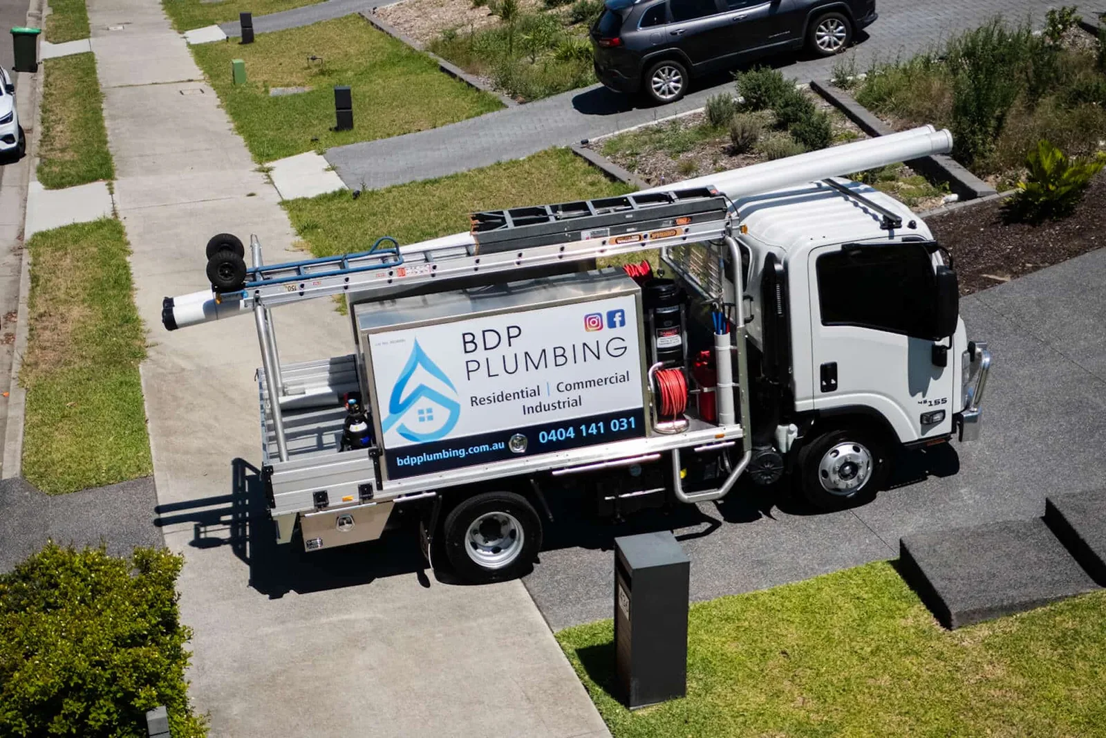 Plumbing service truck parked in a residential street